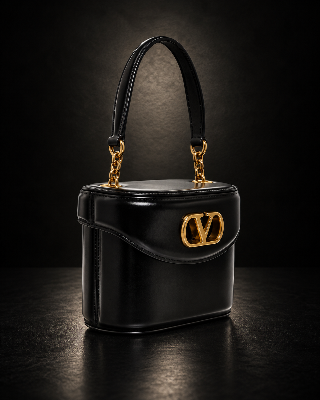 Valentino Garavani Vain Top Handle Bag in black polished calfskin with gold VLogo clasp and chain strap